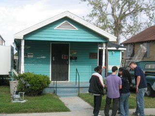 HALO members talking to woman in front of her home