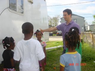 HALO member and local children in front of trailer