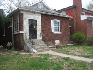 House with uncut lawn and housing violation sign