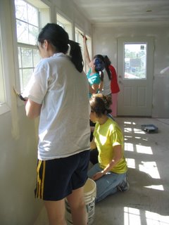 HALO members painting inside of house