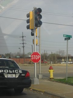 Police car parked next to stop sign