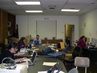 HALO members working at conference tables on laptops