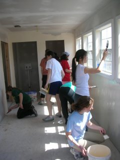 HALO members painting inside of house